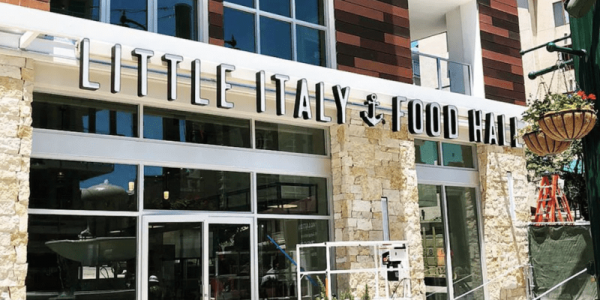 Exterior shot of Little Italy Food Hall on a sunny day